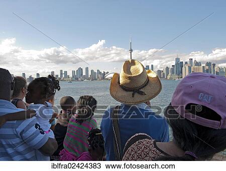 Stock Image - Passengers and tourists on the ferry from Toronto to Centre Island, CN Tower, Lake Ontario, Toronto, province of Ontario, Canada, North America. Fotosearch