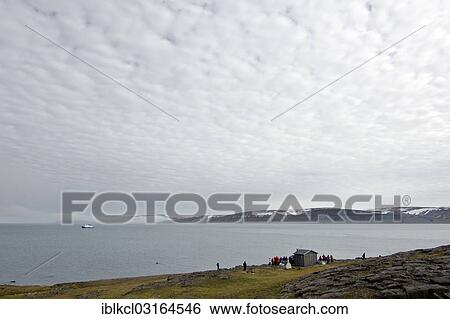 Stock Photograph - "Passengers of an expedition cruise ship visiting the Wuerzburg Hut, remnants of the historic German Staufferland expeditions, Freemansundet, Sundneset, Barentsoya, Svalbard Archipelago, Svalbard and Jan Mayen, Norway, Europe". Fotosearch