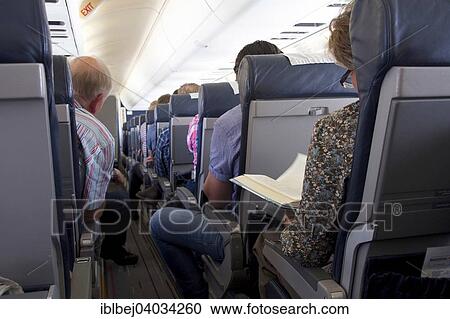Stock Image - Passengers on an airplane. Fotosearch