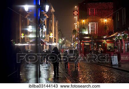 "Passers-by in the street outside The Temple Bar, at night, Dublin, Leinster, Ireland, Europe" View Large Photo Image Stock Image - "Passers-by in the street outside The Temple Bar, at night, Dublin, Leinster, Ireland, Europe". Fotosearch