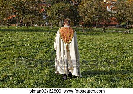 "Pastor walking across a meadow, Wildsteig, Pfaffenwinkel region, Upper Bavaria, Bavaria, Germany, Europe" View Large Photo Image Stock Image - "Pastor walking across a meadow, Wildsteig, Pfaffenwinkel region, Upper Bavaria, Bavaria, Germany, Europe". Fotosearch