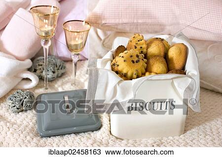 Stock Image - "Pastries in a tin labelled """"Biscuits""""". Fotosearch
