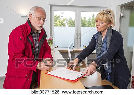 "Patient filling in a form at the reception of a dental office, Germany, Europe" View Large Photo Image Stock Photograph - "Patient filling in a form at the reception of a dental office, Germany, Europe". Fotosearch