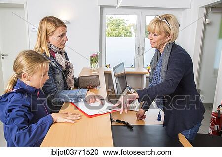"Patients filling in a form at the reception of a dental office, Germany, Europe" View Large Photo Image Stock Image - "Patients filling in a form at the reception of a dental office, Germany, Europe". Fotosearch