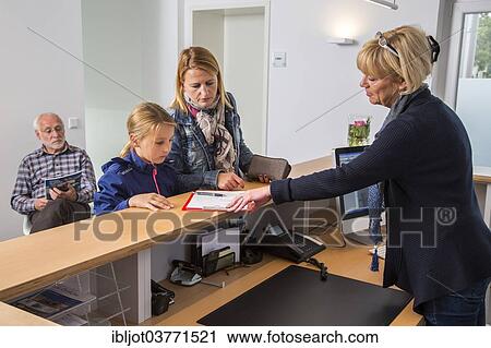 "Patients filling in a form at the reception of a dental office, Germany, Europe" View Large Photo Image Stock Image - "Patients filling in a form at the reception of a dental office, Germany, Europe". Fotosearch