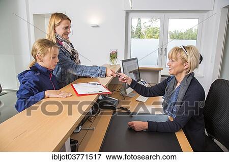"Patients filling in a form at the reception of a dental office, Germany, Europe" View Large Photo Image Stock Photo - "Patients filling in a form at the reception of a dental office, Germany, Europe". Fotosearch