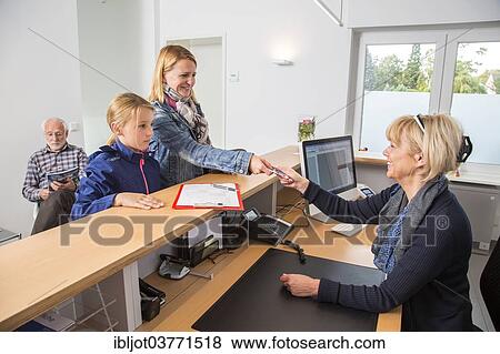 "Patients filling in a form at the reception of a dental office, Germany, Europe" View Large Photo Image Stock Photo - "Patients filling in a form at the reception of a dental office, Germany, Europe". Fotosearch