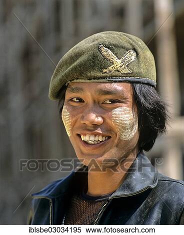 Stock Photography - "Patriotic young man with thanaka paste on his face, wearing an army cap and a leather jacket, Tachilek, Shan State, Myanmar, Burma, Asia". Fotosearch