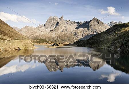 "Patteriol Mountain, 3056m, reflected in Langer See lake, Silbertal, Vorarlberg, Austria, Europe" View Large Photo Image Stock Image - "Patteriol Mountain, 3056m, reflected in Langer See lake, Silbertal, Vorarlberg, Austria, Europe". Fotosearch