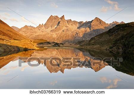 Stock Photo - "Patteriol Mountain, 3056m, reflected in Langer See lake, Silbertal, Vorarlberg, Austria, Europe". Fotosearch