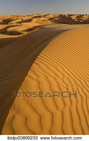 "Patterns of the sand dunes of the Wahiba Sands desert, also known as Ramlat al-Wahiba or Sharqiya Sands, in evening light, Hawiyah, Ash Sharqiyah, Oman, Asia" View Large Photo Image Stock Image - "Patterns of the sand dunes of the Wahiba Sands desert, also known as Ramlat al-Wahiba or Sharqiya Sands, in evening light, Hawiyah, Ash Sharqiyah, Oman, Asia". Fotosearch