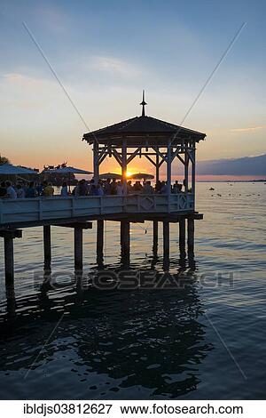 "Pavilion with a bar on Lake Constance, at sunset, Bregenz, Vorarlberg, Austria, Europe" View Large Photo Image Stock Photo - "Pavilion with a bar on Lake Constance, at sunset, Bregenz, Vorarlberg, Austria, Europe". Fotosearch