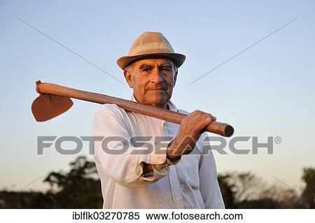 "Peasant farmer, 70, holding a hoe, Pastoreo, Caaguazu Department, Paraguay, South America" View Large Photo Image Stock Photography - "Peasant farmer, 70, holding a hoe, Pastoreo, Caaguazu Department, Paraguay, South America". Fotosearch