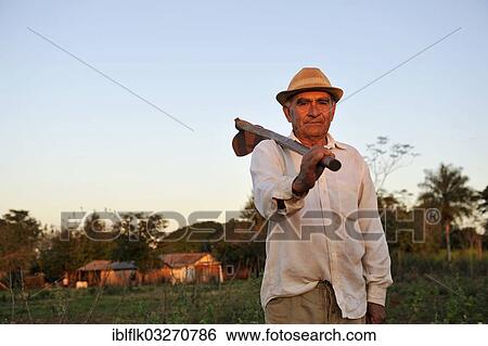 "Peasant farmer, 70, standing with a hoe on a field, Pastoreo, Caaguazu Department, Paraguay, South America" View Large Photo Image Stock Photograph - "Peasant farmer, 70, standing with a hoe on a field, Pastoreo, Caaguazu Department, Paraguay, South America". Fotosearch