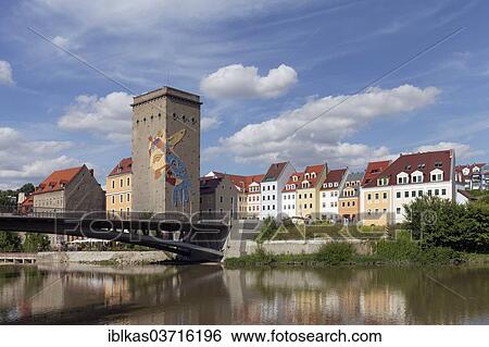 Stock Photograph - "Pedestrian bridge over the Neisse River to Zgorzelec, grain silo of the former Dreiradenmuehle mill, Gorlitz, Saxony, Germany, Europe". Fotosearch