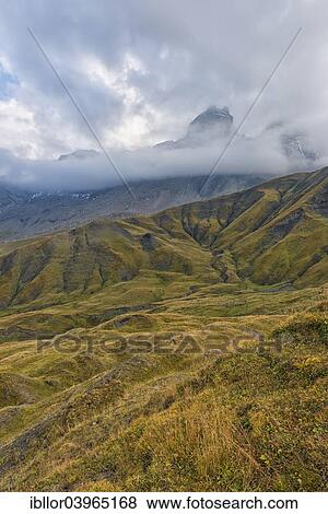 Stock Photo - "Pelvoux landscape with the Les Aiguilles d'Arves mountain between fog and clouds, Pelvoux, Dauphine Alps, Savoie, France, Europe". Fotosearch