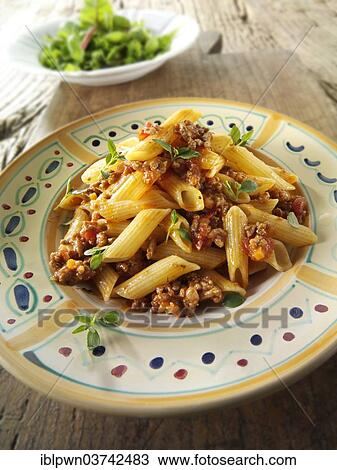 Stock Image - Penne pasta with a Bolognese sauce. Fotosearch