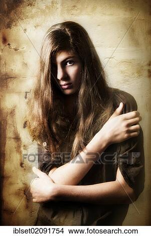 Picture - "Pensive girl, aged 13, with long hair, artistic portrait". Fotosearch