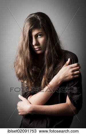 Stock Image - "Pensive girl, aged 13, with long hair, portrait". Fotosearch