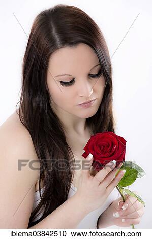 Pensive young woman with a red rose View Large Photo Image Stock Image - Pensive young woman with a red rose. Fotosearch
