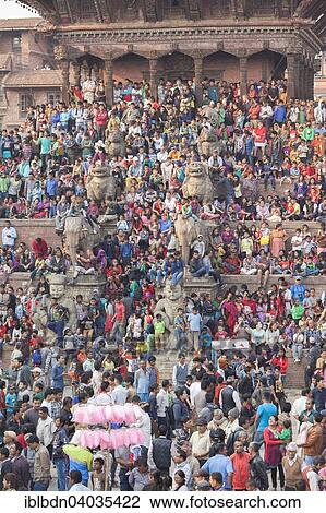 Stock Image - "People at Taumadhi Tol square, traditional chariot race, Bisket Jatra New Year celebrations, Bhaktapur, Nepal, Asia". Fotosearch