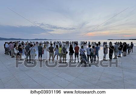 "People at the Monument to the Sun, Pozdrav Suncu, by architect Nikole Basica, at dusk, Zadar, Dalmatia, Croatia, Europe" View Large Photo Image Stock Photograph - "People at the Monument to the Sun, Pozdrav Suncu, by architect Nikole Basica, at dusk, Zadar, Dalmatia, Croatia, Europe". Fotosearch