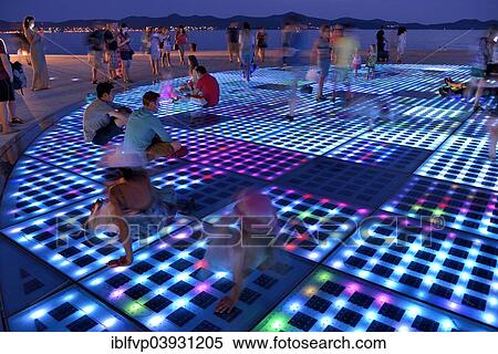"People at the Monument to the Sun, Pozdrav Suncu, by architect Nikole Basica, at dusk, Zadar, Dalmatia, Croatia, Europe" View Large Photo Image Stock Photography - "People at the Monument to the Sun, Pozdrav Suncu, by architect Nikole Basica, at dusk, Zadar, Dalmatia, Croatia, Europe". Fotosearch