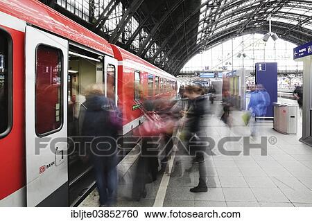"People boarding a train, platform at Cologne Central Railway Station or Hauptbahnhof, Cologne, North Rhine-Westphalia, Germany, Europe" View Large Photo Image Stock Image - "People boarding a train, platform at Cologne Central Railway Station or Hauptbahnhof, Cologne, North Rhine-Westphalia, Germany, Europe". Fotosearch