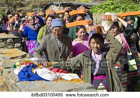 Stock Photography - "People carrying tibetean prayer books, wrapped in yellow material, on their heads at Lhapab Tuchen festival, Bhandar, Solukhumbu District, Sagarmatha Zone, Nepal, Asia". Fotosearch