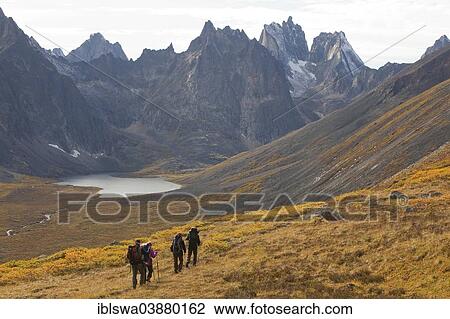 "People hiking in arctic or subalpine tundra, Grizzly Lake and Mount Monolith behind, Indian summer, Tombstone Mountains Territorial Park, Yukon Territory, Canada, North America" View Large Photo Image Stock Image - "People hiking in arctic or subalpine tundra, Grizzly Lake and Mount Monolith behind, Indian summer, Tombstone Mountains Territorial Park, Yukon Territory, Canada, North America". Fotosearch