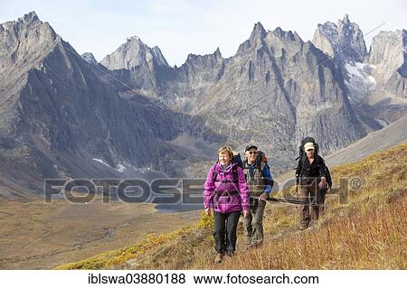 "People hiking in arctic or subalpine tundra, Mount Monolith behind, Indian summer, Tombstone Mountains Territorial Park, Yukon Territory, Canada, North America" View Large Photo Image Stock Photo - "People hiking in arctic or subalpine tundra, Mount Monolith behind, Indian summer, Tombstone Mountains Territorial Park, Yukon Territory, Canada, North America". Fotosearch