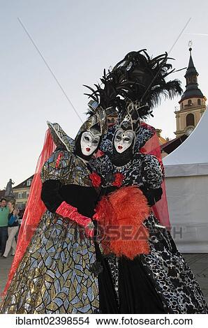 "People in Baroque costumes, masks and lavish headdresses with feathers, Stadtkirche church at back, Venetian Fair, Ludwigsburg, Baden-Wuerttemberg, Germany, Europe" View Large Photo Image Picture - "People in Baroque costumes, masks and lavish headdresses with feathers, Stadtkirche church at back, Venetian Fair, Ludwigsburg, Baden-Wuerttemberg, Germany, Europe". Fotosearch