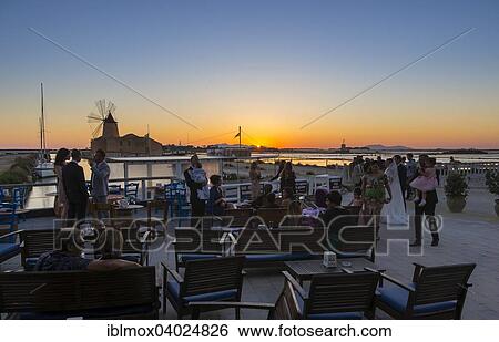 "People on the evening in front of the salt pans Ettore Infersa wind mill with salt museum, Marsala, Laguna Stagnone, Province of Trapani, Sicily, Italy, Europe" View Large Photo Image Stock Photograph - "People on the evening in front of the salt pans Ettore Infersa wind mill with salt museum, Marsala, Laguna Stagnone, Province of Trapani, Sicily, Italy, Europe". Fotosearch
