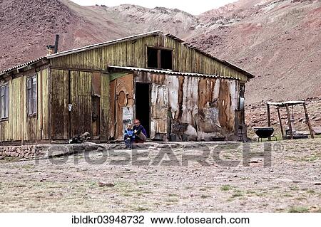 "People sitting outside a delapidated hut, settlement on the Pamir Highway, M41, Province of Gorno-Badakhshan, Tajikistan, Asia" View Large Photo Image Stock Image - "People sitting outside a delapidated hut, settlement on the Pamir Highway, M41, Province of Gorno-Badakhshan, Tajikistan, Asia". Fotosearch