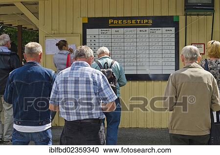 "People standing in front of board with the betting tips just before a horse race, Dresden, Saxony, Germany, Europe" View Large Photo Image Stock Image - "People standing in front of board with the betting tips just before a horse race, Dresden, Saxony, Germany, Europe". Fotosearch