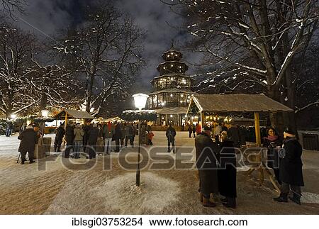 Picture - "People strolling through the Christmas market at the Chinese Tower in the English Garden, Munich, Upper Bavaria, Bavaria, Germany, Europe". Fotosearch