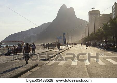Stock Photo - "People walking along the sidewalk at Ipanema Beach, Ipanema, Rio de Janeiro, Rio de Janeiro State, Brazil, South America". Fotosearch