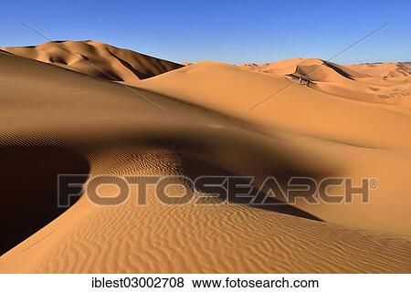 Stock Photo - "People walking on a sand dune, Sahara Desert, Immidir or Mouydir, Erg Mehejibad, Tamanrasset Province, Algeria, Africa". Fotosearch