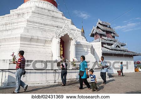 Stock Photo - "People with offerings walking around a Pagoda or Chedi, Temple complex of Wat Phra That Doi Kong Mu, Mae Hong Son, Northern Thailand, Thailand, Asia". Fotosearch