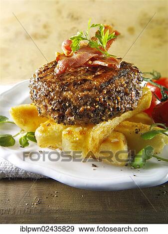 Peppered beef burger on thick cut chips View Large Photo Image Stock Photo - Peppered beef burger on thick cut chips. Fotosearch