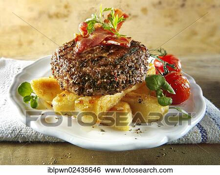 Stock Photograph - Peppered beef burger on thick cut chips. Fotosearch