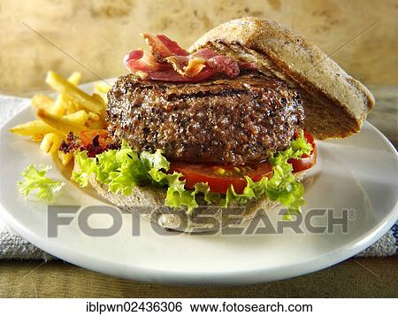 Peppered beef burger with bacon in a wholemeal bun with chips View Large Photo Image Stock Photograph - Peppered beef burger with bacon in a wholemeal bun with chips. Fotosearch