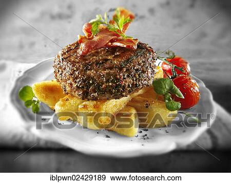 Peppered beef burger with chips View Large Photo Image Stock Photo - Peppered beef burger with chips. Fotosearch