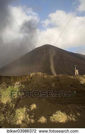 "Person in front of Mount Yasur volcano, Tanna Island, Vanuatu, Oceania" View Large Photo Image Stock Image - "Person in front of Mount Yasur volcano, Tanna Island, Vanuatu, Oceania". Fotosearch