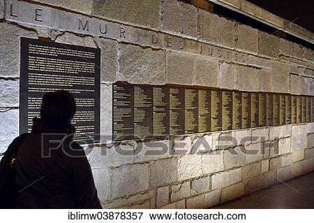 Stock Photo - "Person standing in front of the Le Mur de Justes plaque at the Memorial de la Shoah, central memorial to the Holocaust, Jewish quarter Le Marais, Paris, Ile-de-France, France, Europe". Fotosearch