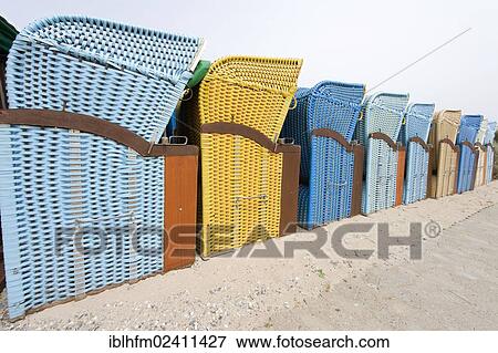 Stock Photo - "Perspective image of a row of blue and yellow roofed wicker beach chairs, Duene Island, Heligoland, Schleswig-Holstein, Germany, Europe". Fotosearch