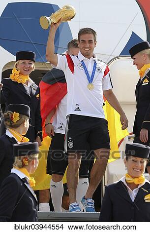 Picture - "Philipp Lahm with the trophy, arrival of the German national team after their victory at the FIFA World Cup 2014 at Tegel, Berlin, Germany Airport". Fotosearch