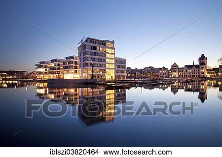 Picture - "Phoenix Lake with the Facharztzentrum medical centre and Horder Burg Castle at the blue hour, Dortmund, North Rhine-Westphalia, Germany, Europe". Fotosearch
