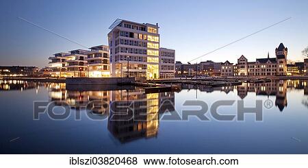 Stock Photo - "Phoenix Lake with the Facharztzentrum medical centre and Horder Burg Castle at the blue hour, Dortmund, North Rhine-Westphalia, Germany, Europe". Fotosearch