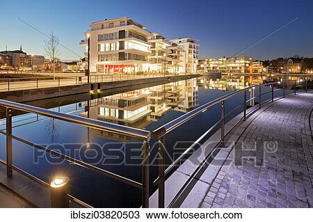 Stock Image - "Phoenix Lake with the waterfront and the Facharztzentrum medical centre at the blue hour, Dortmund, North Rhine-Westphalia, Germany, Europe". Fotosearch